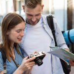 tourist-coupe-outdoors-with-map-camera_23-2148619877